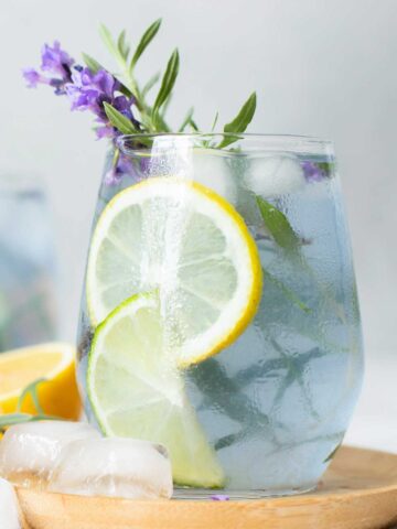 Lavender {title:2:3} in a glass with lavender sprigs and lime slices